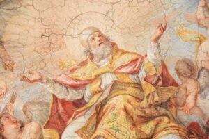 L'immagine mostra un dettaglio dell'affresco della Gloria di San Clemente (1715-1719) dipinto da Giuseppe Chiari al centro del soffitto ligneo della Basilica di San Clemente a Roma.