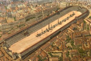 L'immagine mostra una ricostruzione artistica del Circo Massimo a Roma, opera dell'architetto e archeologo francese Jean-Claude Golvin. Si tratta del più grande circo dell'antica Roma, situato nella valle tra il Palatino e l'Aventino.